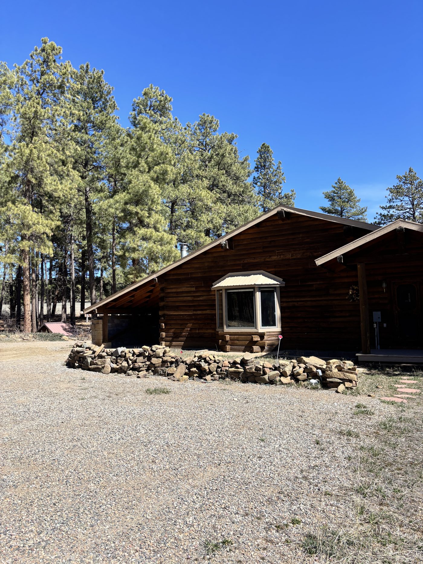 The log ranch home tucked into the ponderosa pines